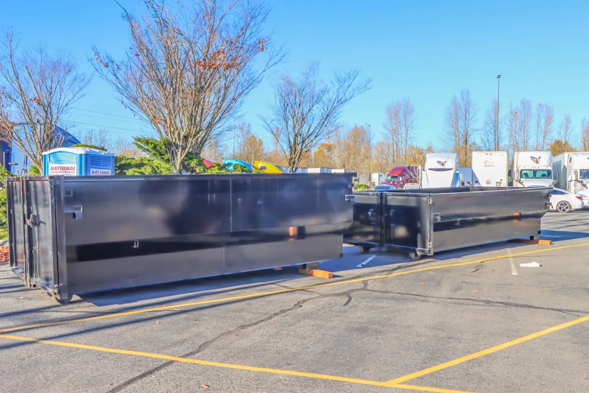 Professional dumpster rental service with roll-off container on residential driveway in Bismarck